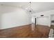 Spacious living area with wood floors, vaulted ceiling, and modern lighting at 8943 N 80Th Pl, Scottsdale, AZ 85258