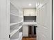 Walk-in pantry featuring ample shelving, beverage cooler, and white cabinetry at 8943 N 80Th Pl, Scottsdale, AZ 85258