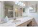 Well-lit bathroom featuring a large mirror, vanity, and walk-in shower at 9128 W Kimberly Way, Peoria, AZ 85382