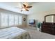 Comfortable bedroom boasts ceiling fan, natural lighting, and stylish decor at 9128 W Kimberly Way, Peoria, AZ 85382