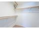 Bright, walk-in closet featuring carpeted floor and wood shelving for optimal storage at 9128 W Kimberly Way, Peoria, AZ 85382
