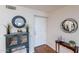 Inviting entryway with wood floors, decorative cabinet, stylish decor, and neutral paint creating a warm ambiance at 9128 W Kimberly Way, Peoria, AZ 85382