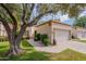 Charming one-story home featuring stucco siding, lush green lawn, mature landscaping, and a two-car garage at 9128 W Kimberly Way, Peoria, AZ 85382