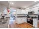 Bright eat-in kitchen boasts stainless steel appliances and open access to living room at 9128 W Kimberly Way, Peoria, AZ 85382