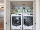 Convenient laundry room with side-by-side washer and dryer, plus overhead storage at 9128 W Kimberly Way, Peoria, AZ 85382