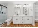 Bathroom with dual sinks, modern fixtures, and a walk-in shower; all exuding style and functionality at 9280 W Wenden Dr, Arizona City, AZ 85123