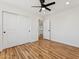 This bedroom boasts hardwood floors, neutral walls, closet and an open door at 9280 W Wenden Dr, Arizona City, AZ 85123