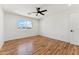 Sunny bedroom features a ceiling fan and a window at 9280 W Wenden Dr, Arizona City, AZ 85123