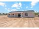 Rear exterior view with a covered patio and generous yard space, perfect for outdoor enjoyment at 9280 W Wenden Dr, Arizona City, AZ 85123