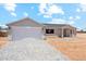Single-story home with an attached garage and gray brick driveway at 9280 W Wenden Dr, Arizona City, AZ 85123