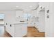 A sleek kitchen featuring white cabinets, a center island, and modern fixtures at 9280 W Wenden Dr, Arizona City, AZ 85123
