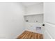 This functional laundry room offers built-in shelving and essential hookups for appliances at 9280 W Wenden Dr, Arizona City, AZ 85123