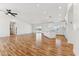 Bright open-concept living space features hardwood floors, recessed lighting, and a ceiling fan at 9280 W Wenden Dr, Arizona City, AZ 85123