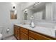 Bathroom featuring marble counters, modern sink with silver fixtures, and decorative mirror at 100 E Geneva Dr, Tempe, AZ 85282