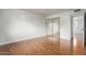 Bright bedroom features wood floors, sliding mirror closet doors, and an open doorway at 100 E Geneva Dr, Tempe, AZ 85282