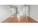 Bright bedroom features wood floors, sliding mirror closet doors, and an open doorway at 100 E Geneva Dr, Tempe, AZ 85282