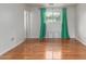 This bright bedroom features hardwood floors and natural light at 100 E Geneva Dr, Tempe, AZ 85282