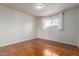 Light filled bedroom with wood floors and neutral paint provides a serene space at 100 E Geneva Dr, Tempe, AZ 85282