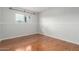 Light filled bedroom with wood floors and neutral paint provides a serene space at 100 E Geneva Dr, Tempe, AZ 85282