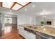 Granite counters and a farmhouse sink define this eat-in kitchen at 100 E Geneva Dr, Tempe, AZ 85282