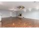 Open living room with hardwood floors, fireplace, and modern lighting fixtures at 100 E Geneva Dr, Tempe, AZ 85282