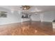 Spacious living room with hardwood floors open to kitchen, and modern ceiling fan at 100 E Geneva Dr, Tempe, AZ 85282