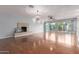 Expansive living area featuring wood floors, a fireplace, and large sliding doors to the patio at 100 E Geneva Dr, Tempe, AZ 85282