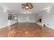 Bright living room with hardwood floors, fireplace, and modern ceiling fan at 100 E Geneva Dr, Tempe, AZ 85282