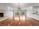 Open living room with wood flooring, a fireplace, and access to the backyard at 100 E Geneva Dr, Tempe, AZ 85282