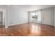 Bright, open living room with wood floors, a window, and a doorway to another room at 100 E Geneva Dr, Tempe, AZ 85282