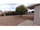 Backyard with orange tree, gravel, and block wall at 1033 S Florence Dr, Mesa, AZ 85208