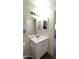 Bathroom features a white vanity, mirror, and access to other rooms at 1033 S Florence Dr, Mesa, AZ 85208