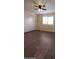 Bedroom with wood-look floors, ceiling fan, closet, and natural light from window with white shutters at 1033 S Florence Dr, Mesa, AZ 85208