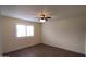 Comfortable bedroom with natural light, vinyl floors, and modern ceiling fan at 1033 S Florence Dr, Mesa, AZ 85208