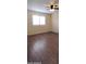 Cozy bedroom with neutral paint, vinyl flooring, plantation shutters, and ceiling fan at 1033 S Florence Dr, Mesa, AZ 85208