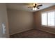 Bedroom with neutral carpet, ceiling fan, and window with plantation shutters at 1033 S Florence Dr, Mesa, AZ 85208