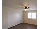Serene bedroom with spacious closet, wood-style flooring, plantation shutters and contemporary lighting at 1033 S Florence Dr, Mesa, AZ 85208