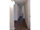 Hallway with hard surface flooring, white walls, and white trim at 1033 S Florence Dr, Mesa, AZ 85208