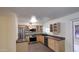 Well-equipped kitchen features stainless steel appliances, wooden cabinets, and a black countertop at 1033 S Florence Dr, Mesa, AZ 85208