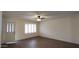 Living room with hard surface flooring, neutral paint, and window shutters at 1033 S Florence Dr, Mesa, AZ 85208