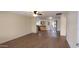 Spacious open-concept living area with modern wood flooring, a ceiling fan, and natural light at 1033 S Florence Dr, Mesa, AZ 85208