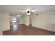 Bright and airy living room with wood floors, fan, and slider doors to patio at 1033 S Florence Dr, Mesa, AZ 85208