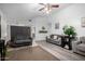 Open-concept living room with neutral decor, vinyl flooring, comfortable sofas, and access to dining area at 10752 W Rio Vista Ln, Avondale, AZ 85323