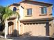 Two-story home featuring a spacious garage, complemented by a well-maintained front yard and architectural detail at 1084 E Saddleback Pl, San Tan Valley, AZ 85143