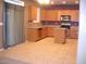 Well-lit kitchen featuring wooden cabinets, stainless steel appliances, and tile flooring at 1084 E Saddleback Pl, San Tan Valley, AZ 85143