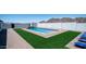 Spacious backyard featuring a sparkling pool, lush turf, and privacy wall, ideal for outdoor gatherings at 10910 N Thunderbird Rd, Maricopa, AZ 85139