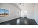 Spacious bedroom with large windows, white walls and attached bathroom at 10910 N Thunderbird Rd, Maricopa, AZ 85139