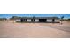 A single-story home with a modern design, stone accents, an attached garage, and a paver driveway at 10910 N Thunderbird Rd, Maricopa, AZ 85139