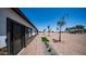 Street view of front exterior featuring detailed stone accents, a paver walkway, and mature desert landscaping at 10910 N Thunderbird Rd, Maricopa, AZ 85139