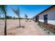 A single-story home with modern design, stone accents, desert landscaping, and a paver walkway at 10910 N Thunderbird Rd, Maricopa, AZ 85139